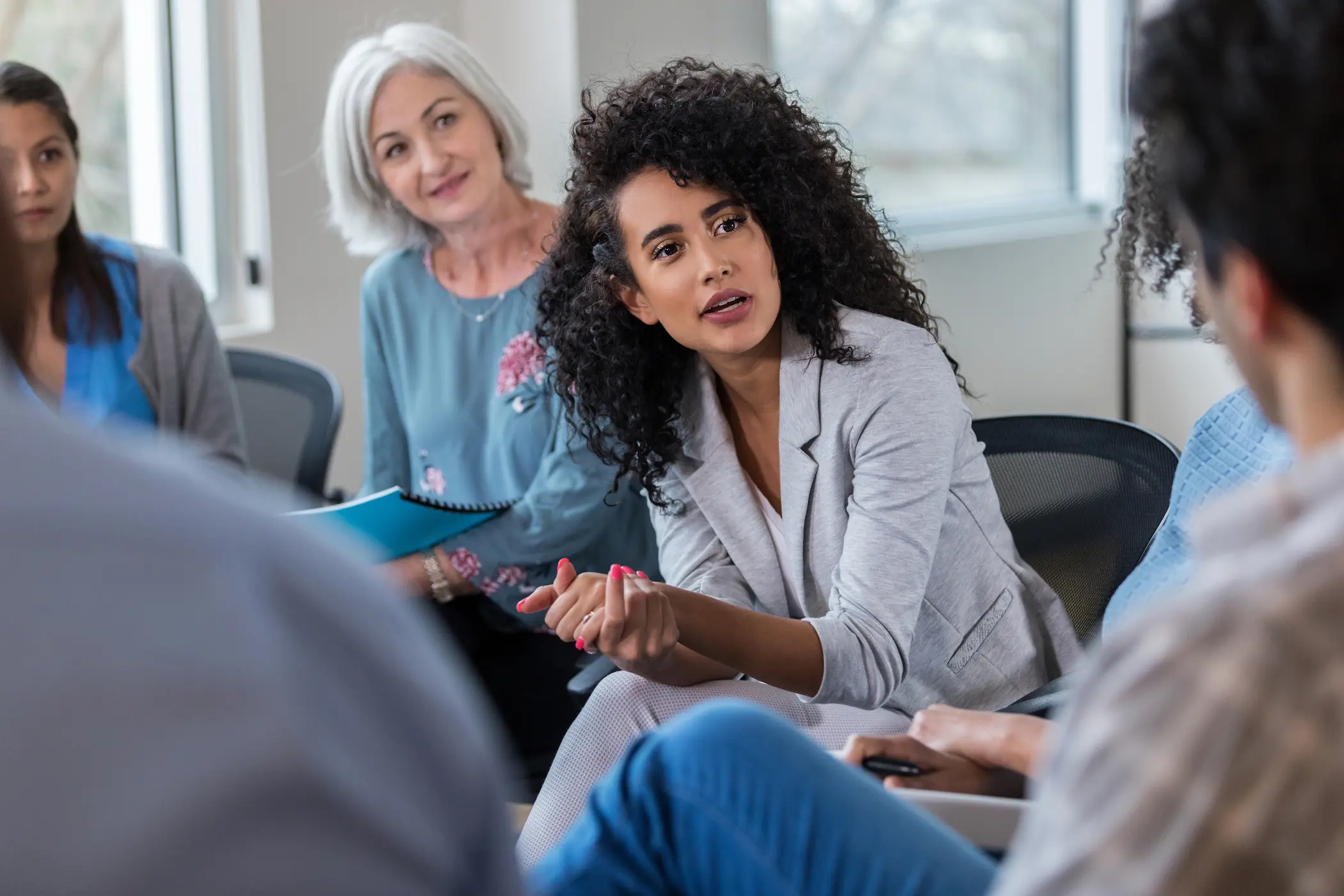 Frau stellt Frage in einem Seminar | 100achtzig°